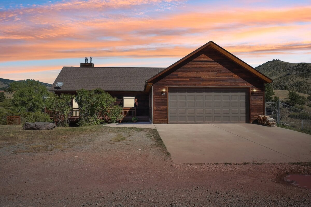 wood exterior single family home with empty land