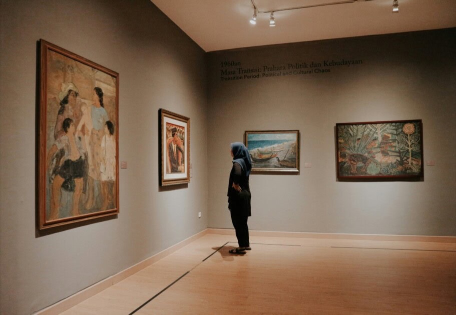 Woman standing in front of art in an art gallery