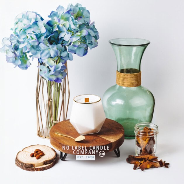 Flower vases and candle surround around coffee beans and tree bark