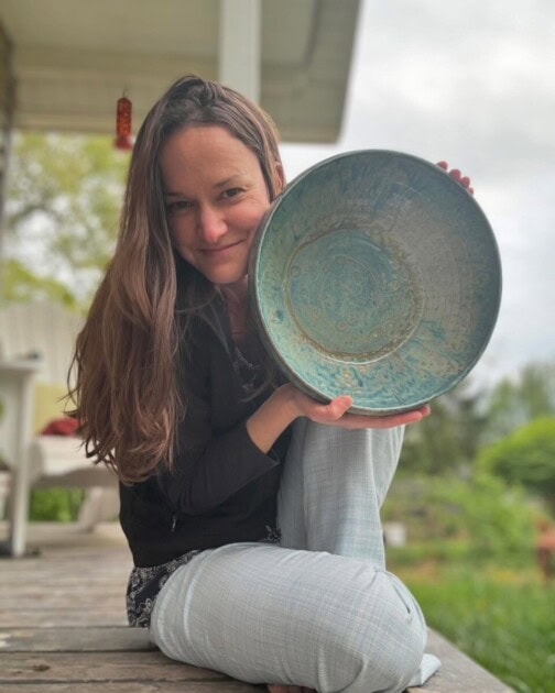 Woman holding pottery bowl